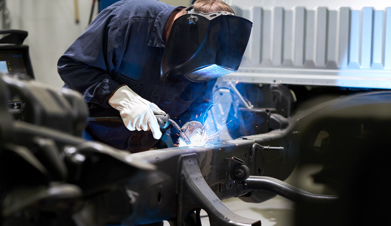 GM Technician Welding a Car Part