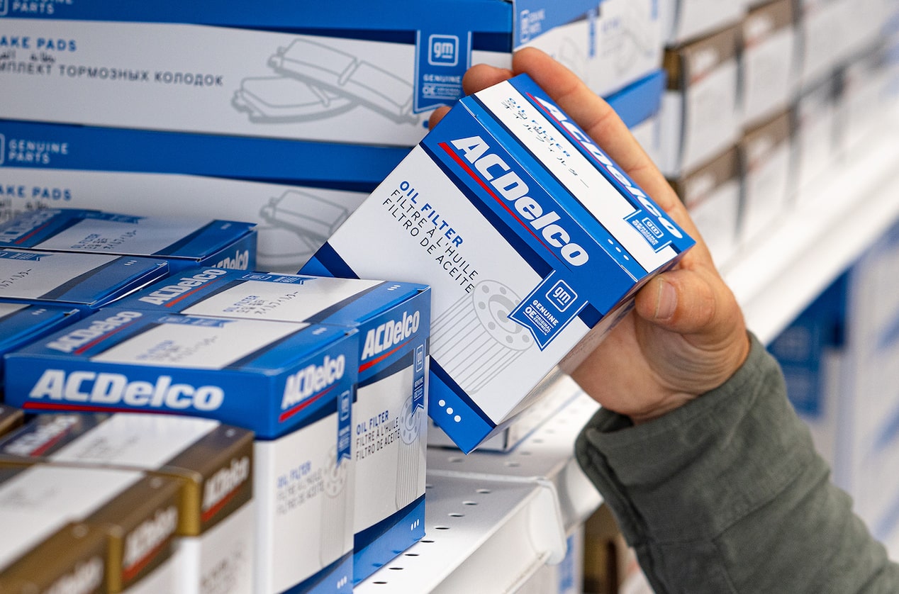 A Person Taking Out an ACDelco Oil Filter Package from the Shelf
