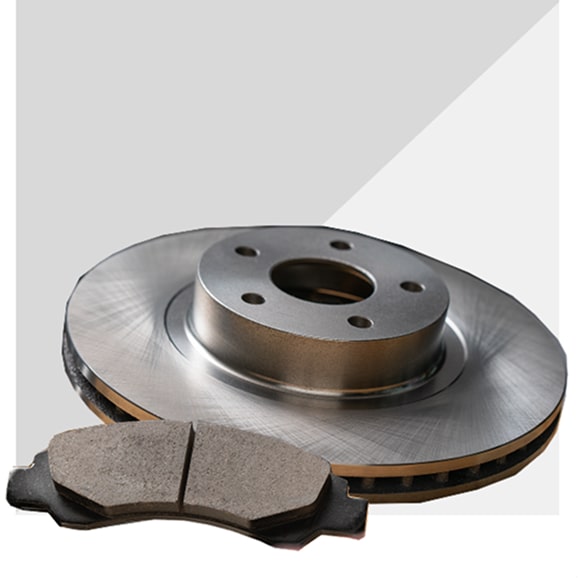 A Disc Brake Rotor Next to a Disc Brake Pad.