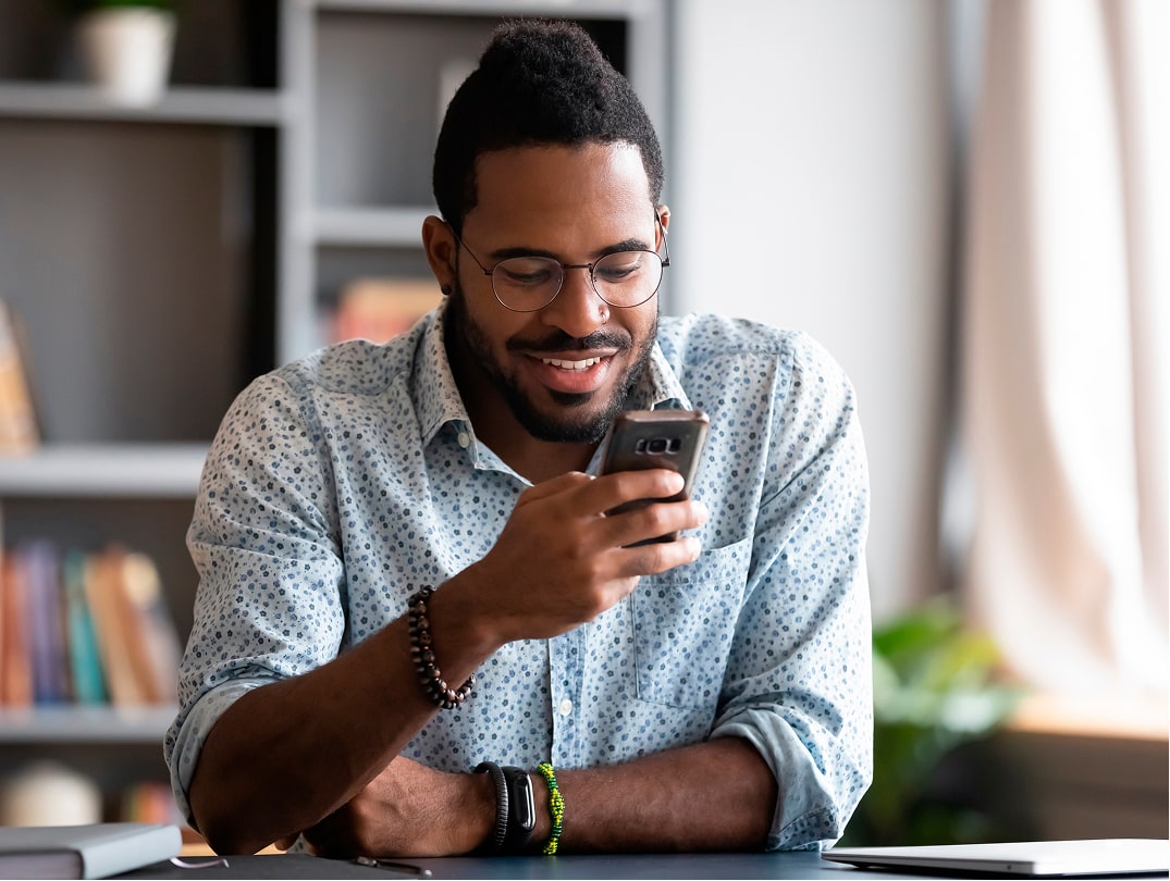 A Man Using A Smartphone For Mobile Parts Ordering