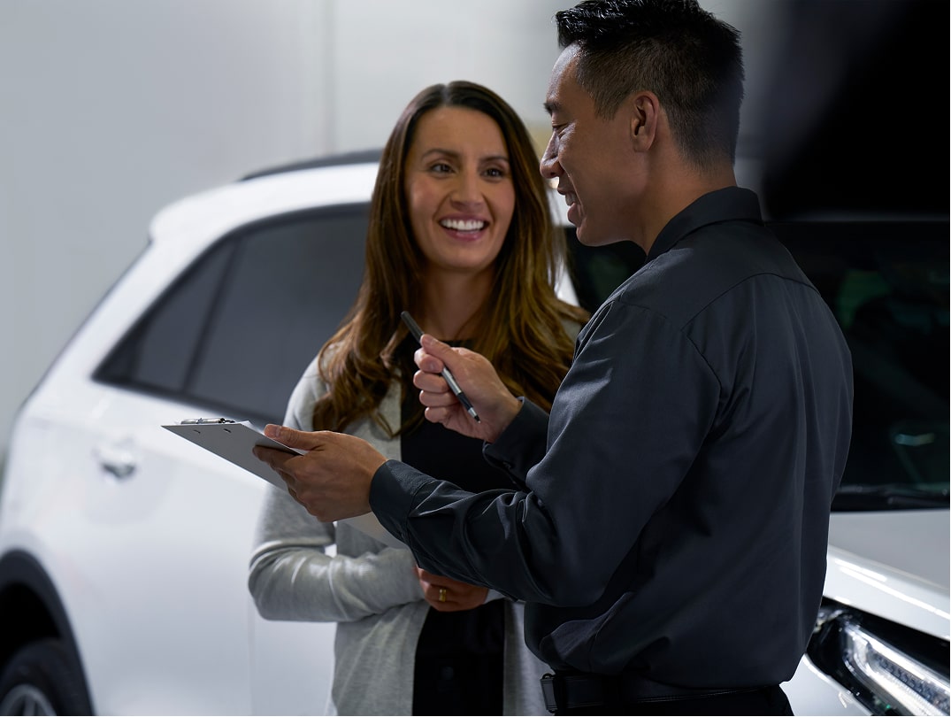 Customer Discussing Auto Repair With A Professional Service Advisor