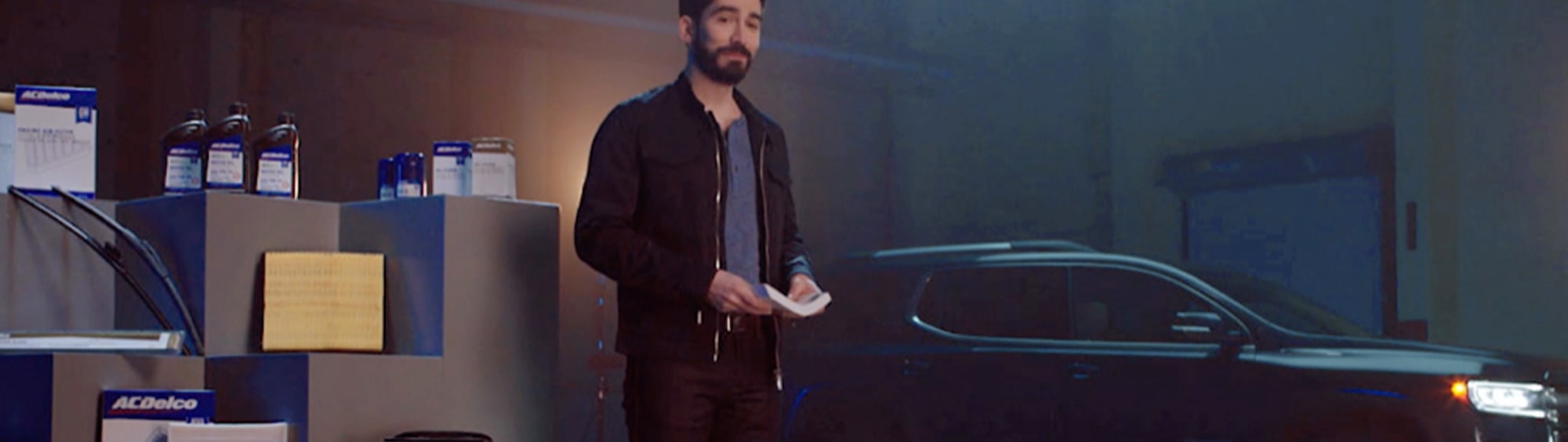 Video Thumbnail a Guy Standing in Front of a Black Vehicle
