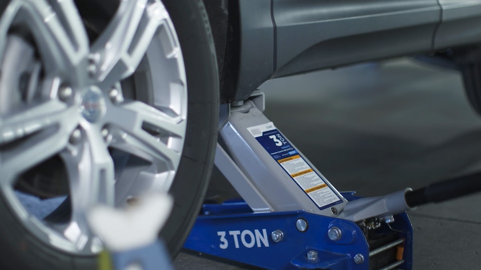 Close-up of a Car Jack Lifting Up a Vehicle