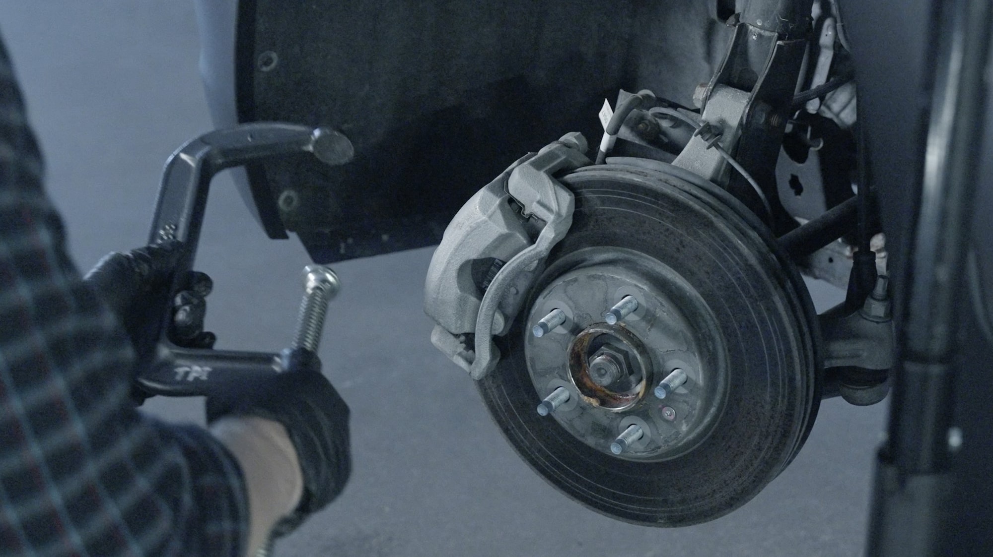Close-up of a Mechanic Working on a Brake Rotor
