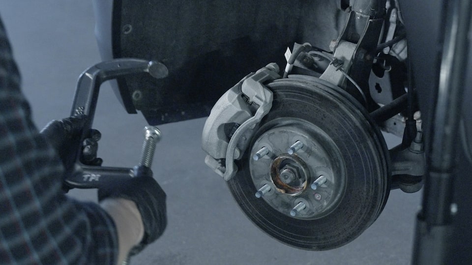 Close-up of a Mechanic Working on a Brake Rotor