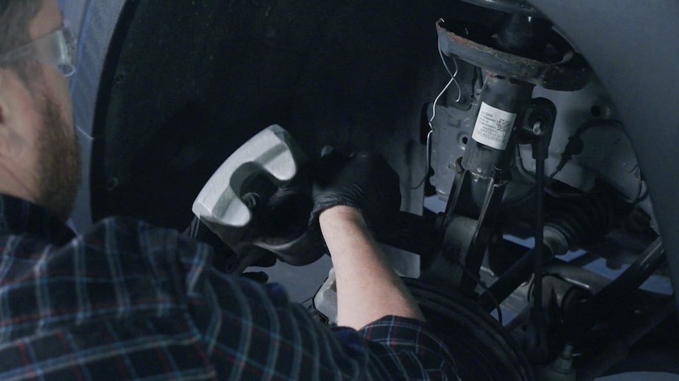 Close-up of a Mechanic Replacing the Brake Pads of a Vehicle