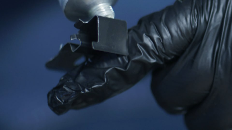 Close-up of a Brake Part Next to a Finger with Gloves On