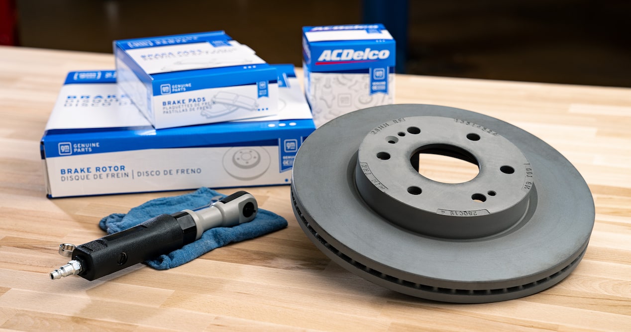 A Brake Rotor with a Tightening Driver along with Cardboard Boxes on a Table