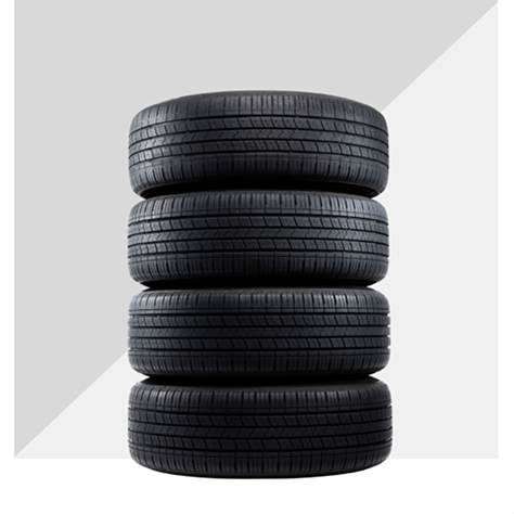 A Stack Of Four Black Rubber Automotive Tires.