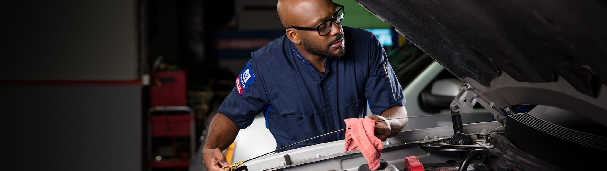 Video Thumbnail of a Mechanic Cleaning the Front Part of the Vehicle under the Hood