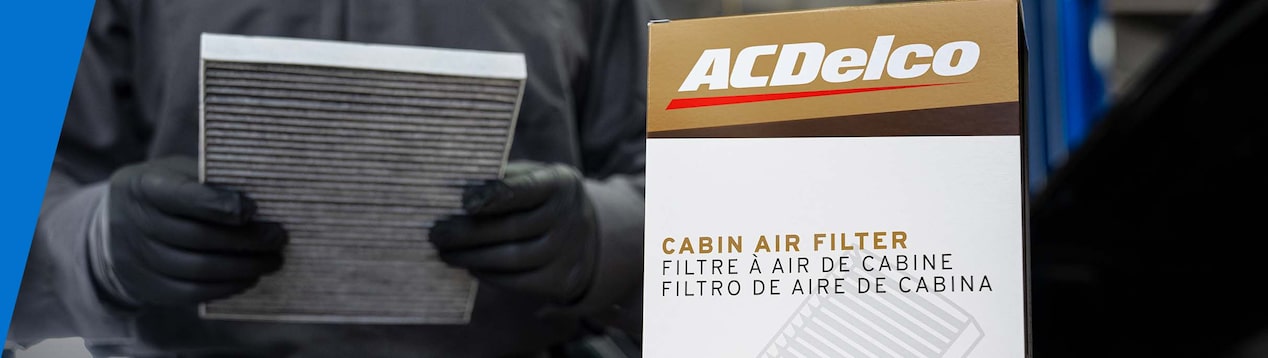 A Person Holding a Bundle of Paper Next to a ACDelco Board