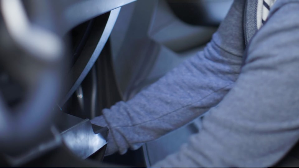 A Man Changing His Own Air Filter on a Vehicle.
