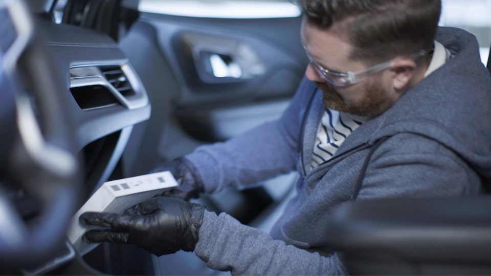 A Side View of a Man Changing His Air Filter.