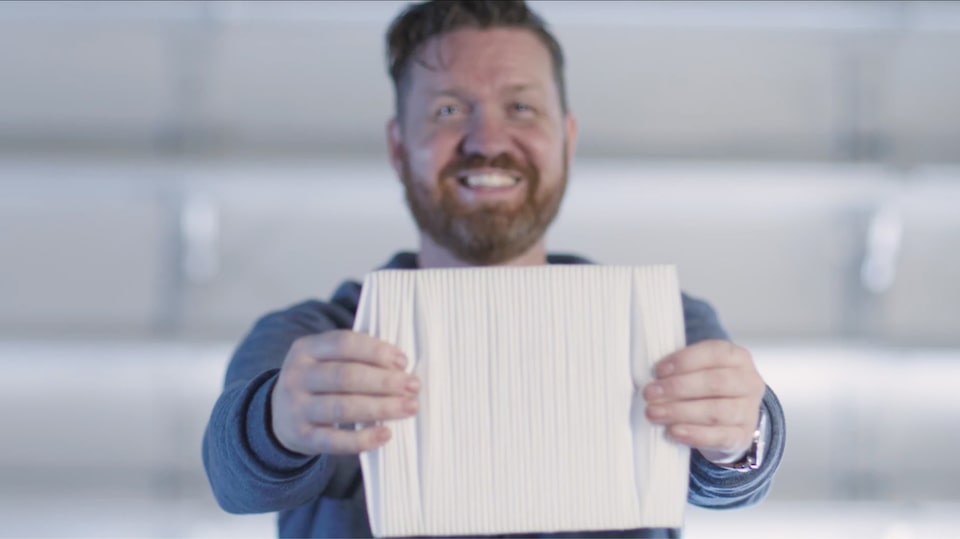 A Man Holding his Vehicle Air Filter Smiling.