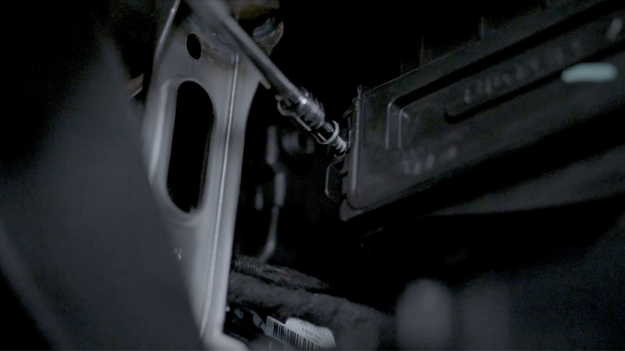 A Close-up View of a Technician Screwing the Filter Box Closed.