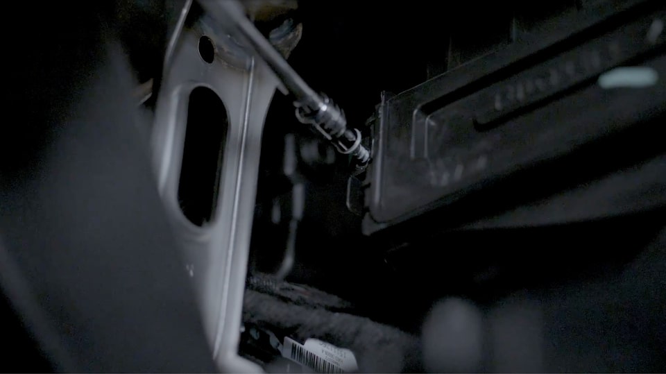 A Close-up View of a Technician Screwing the Filter Box Closed.