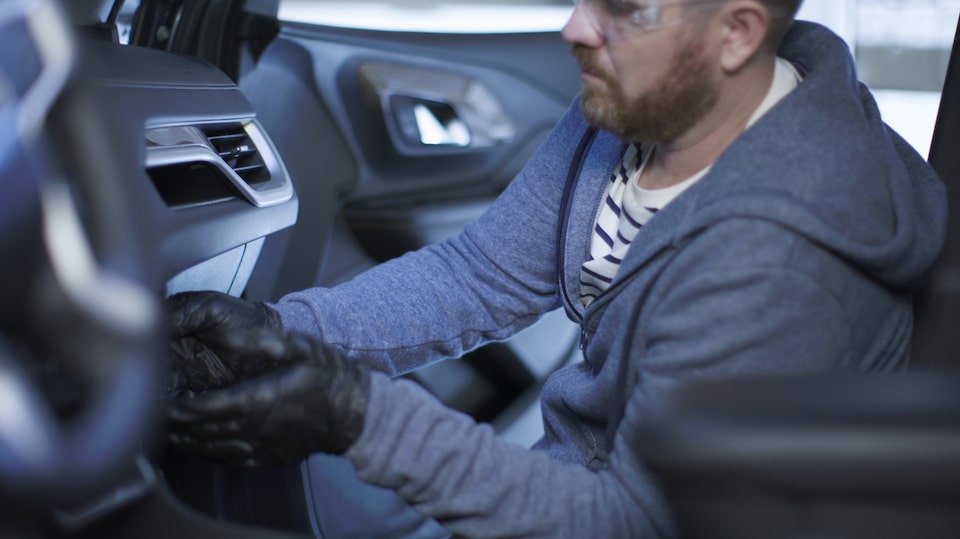 A Side View of a Man Changing His Air Filter.