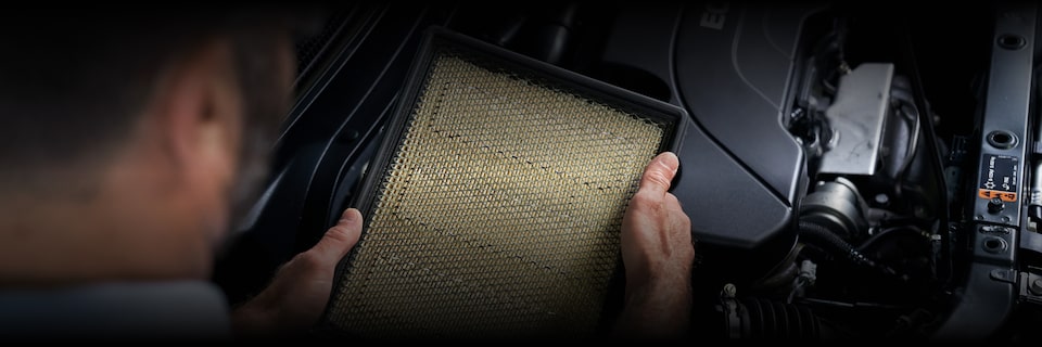 A Service Technician Inspecting an Engine Air Filter