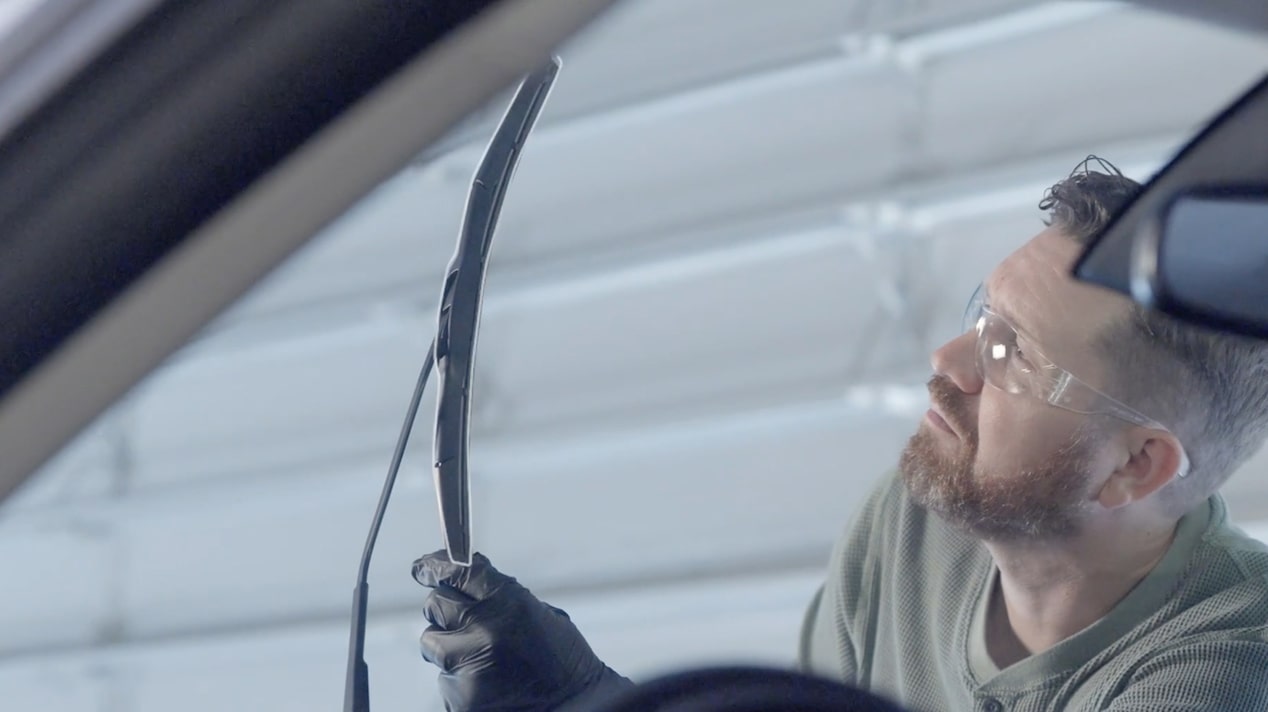 A Mechanic Is Observing a Black Wiper Blade