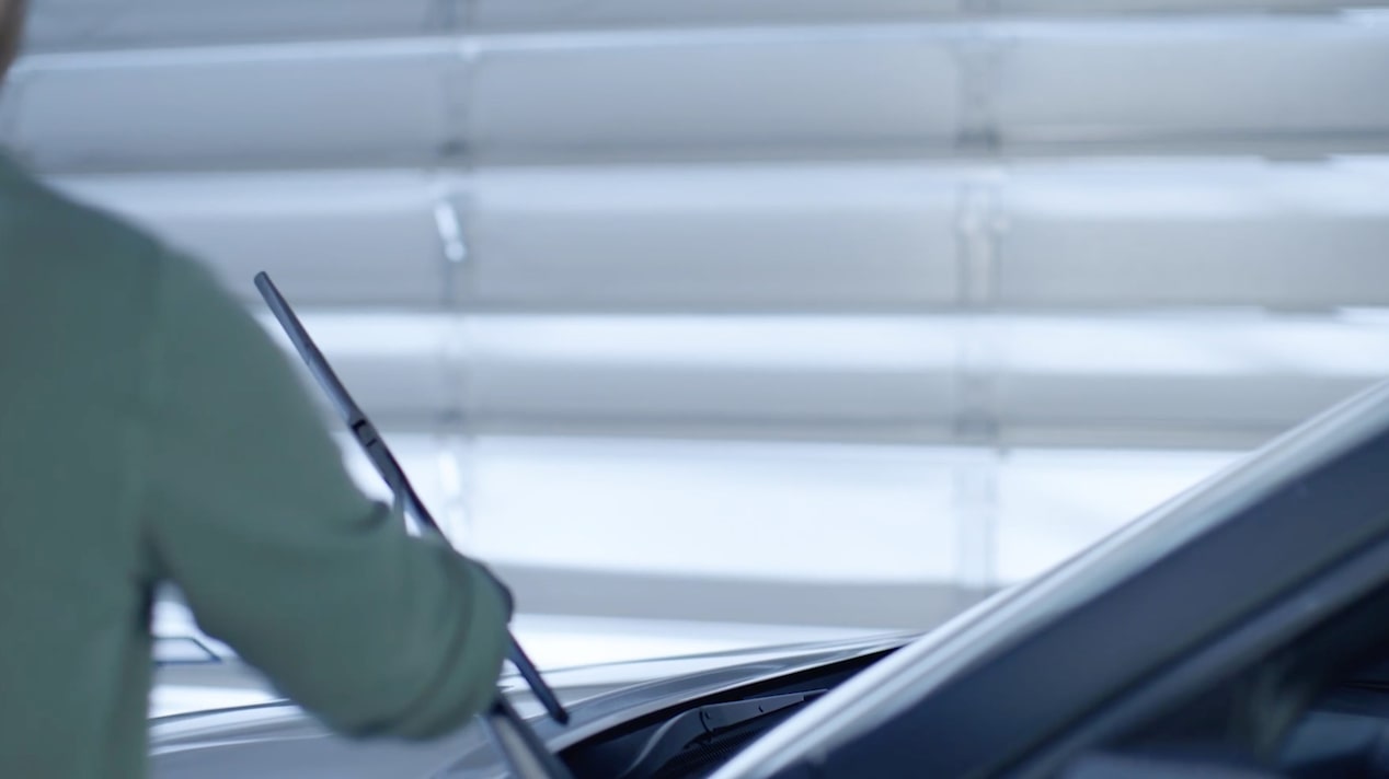 A Mechanic Is Attaching a Wiper Blade in a Car