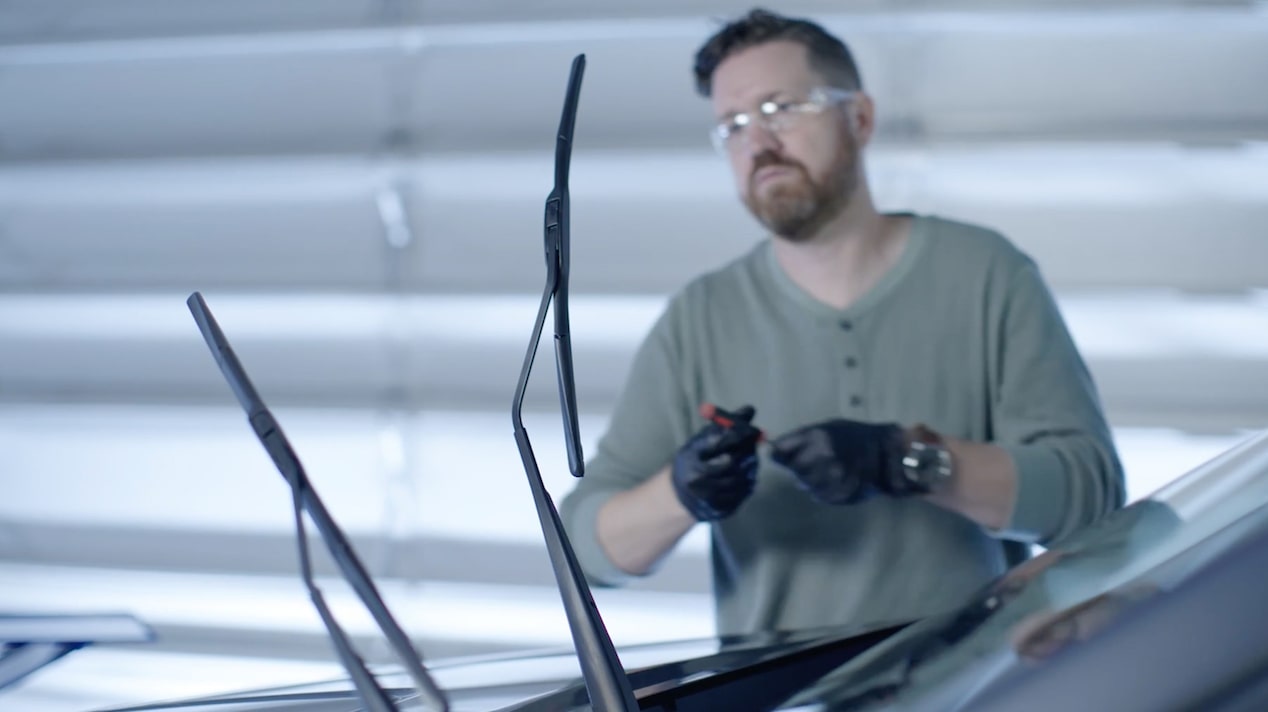 A Mechanic Is Fixing a Wiper Blade in a Car