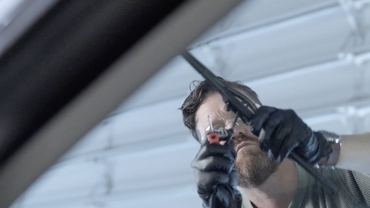 A Mechanic Is Fixing a Wiper Blade in a Car
