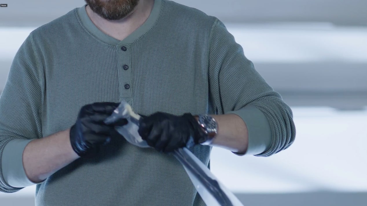 A Mechanic Is Cleaning a Black Windshield Wiper