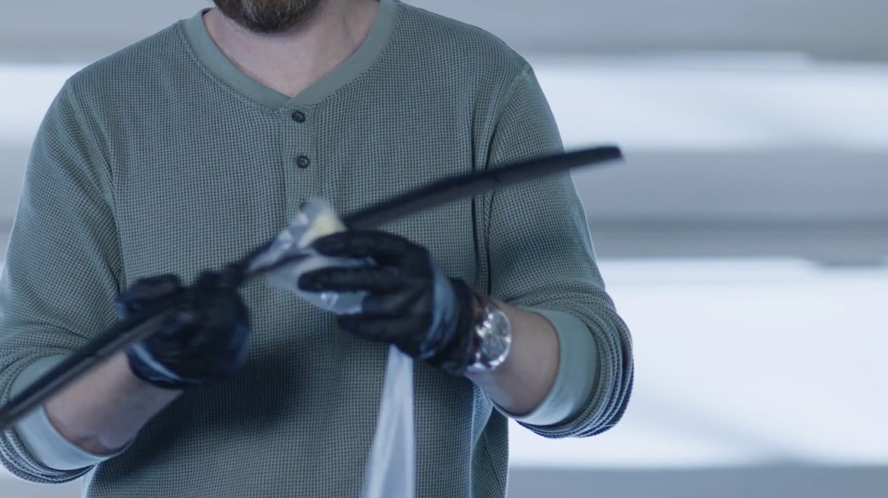 A Mechanic Is Cleaning a Black Windshield Wiper