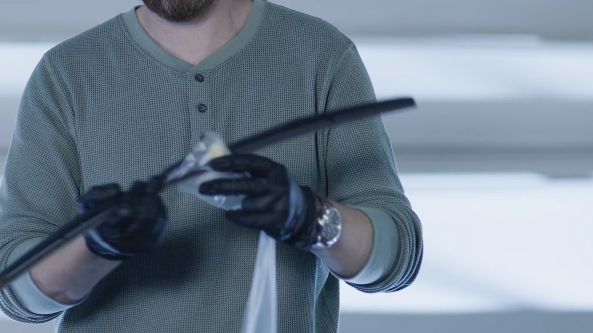 A Mechanic Is Cleaning a Black Windshield Wiper