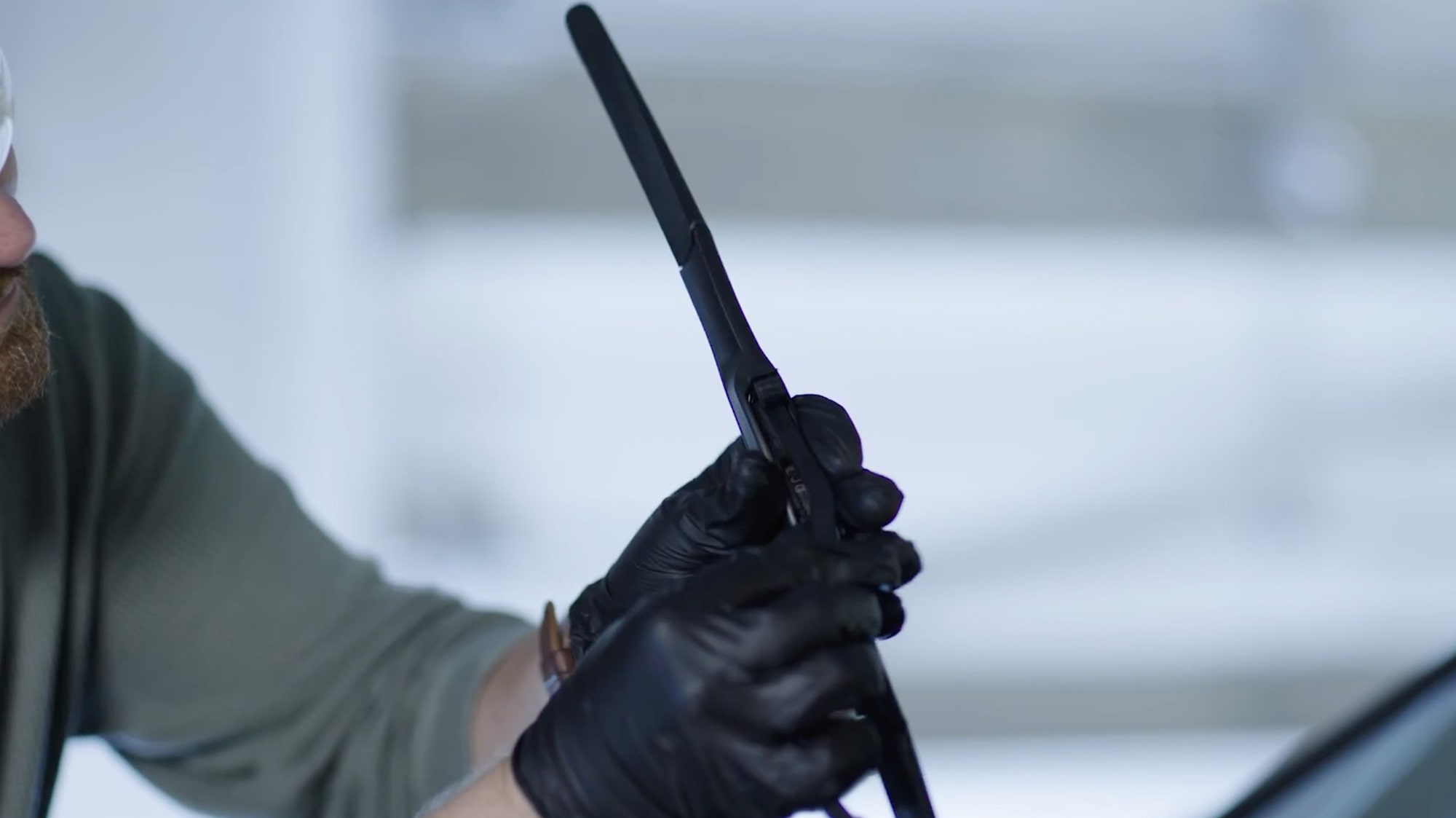 A Mechanic Is Fixing a Windshield Blade in a Car