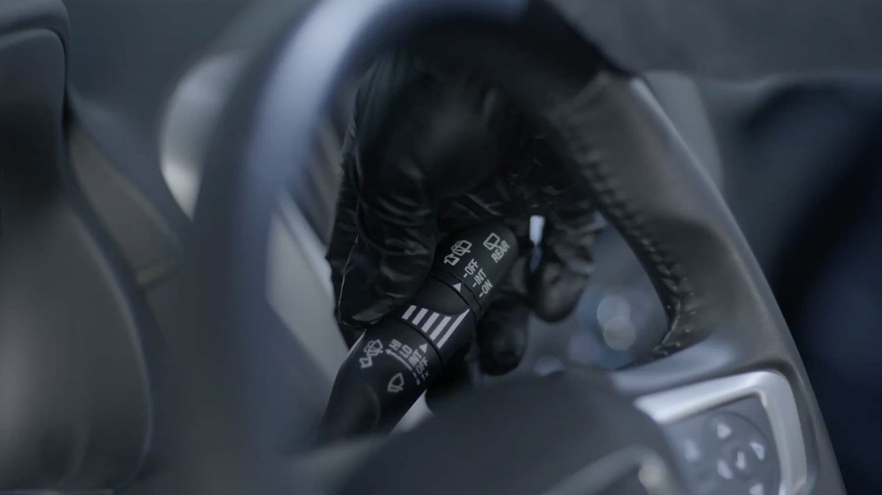 Close-up of a Black Indicator Seen Through a Steering Wheel