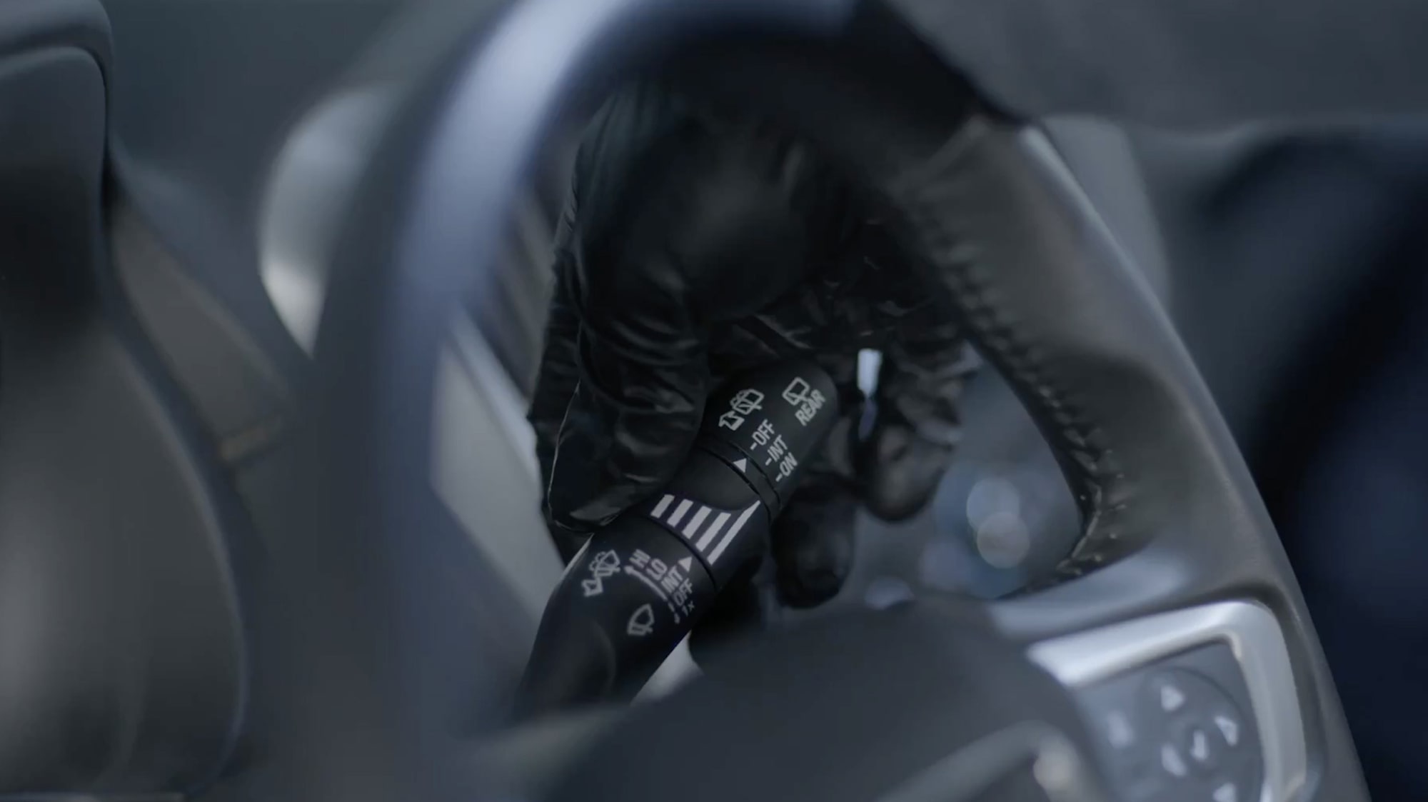 Close-up of a Black Indicator Seen Through a Steering Wheel