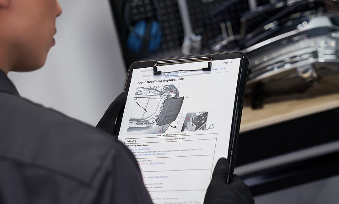 A Mechanic Reading Vehicle Details on a Clipboard