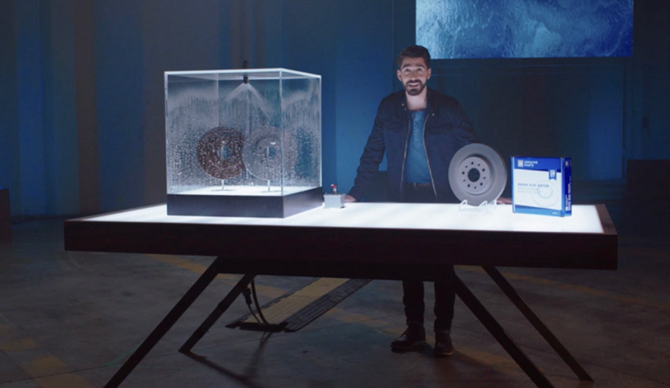 Man Standing at a Table With ACDelco Brake Rotors on Display